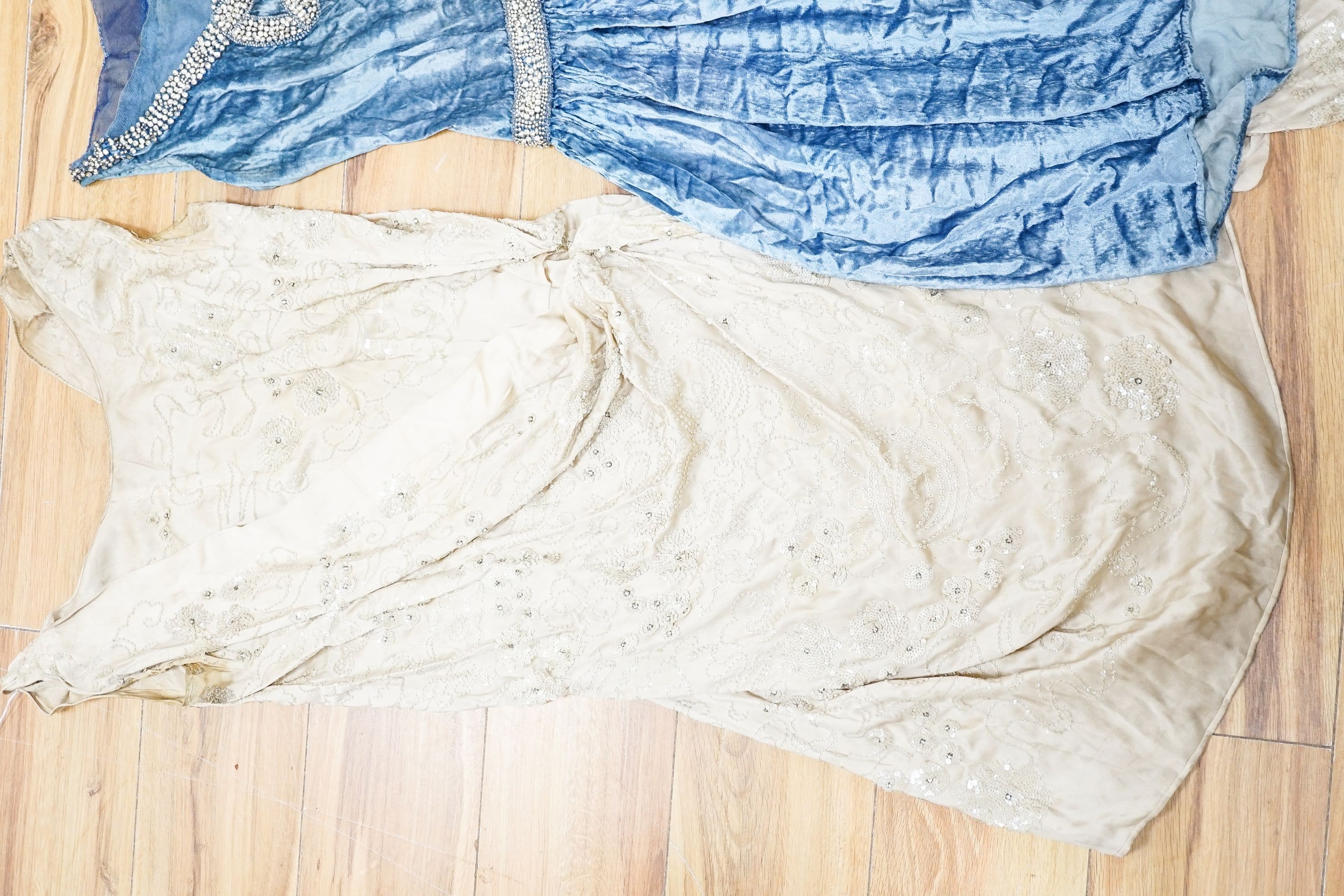 A Victorian black silk evening shawl, a 1920's blue silk velvet decorated with beading together with a beige satin evening dress